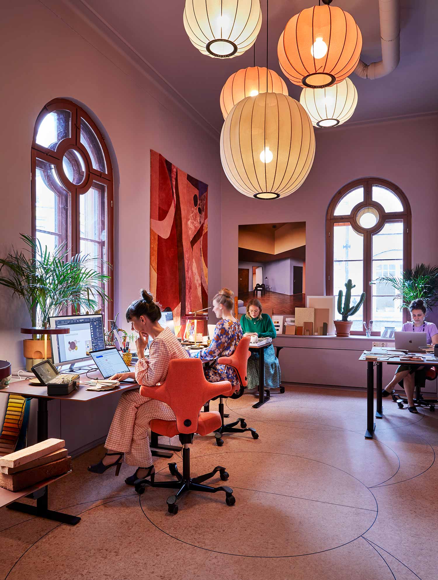 Koi Colour studio office interior with HÅG Capisco chair in coral and soft lighting