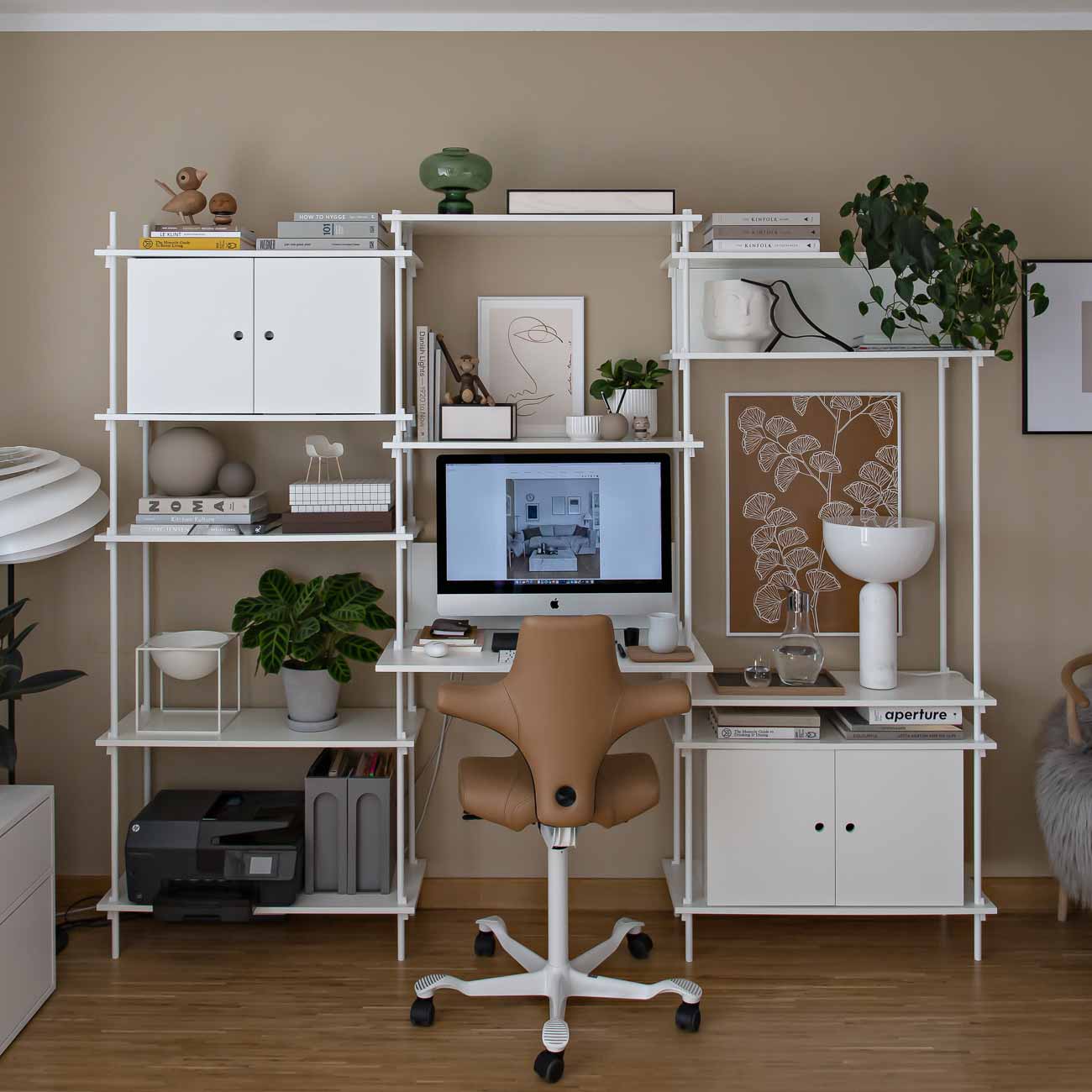 back view of hag capisco chair in brown paloma leather in home workspace