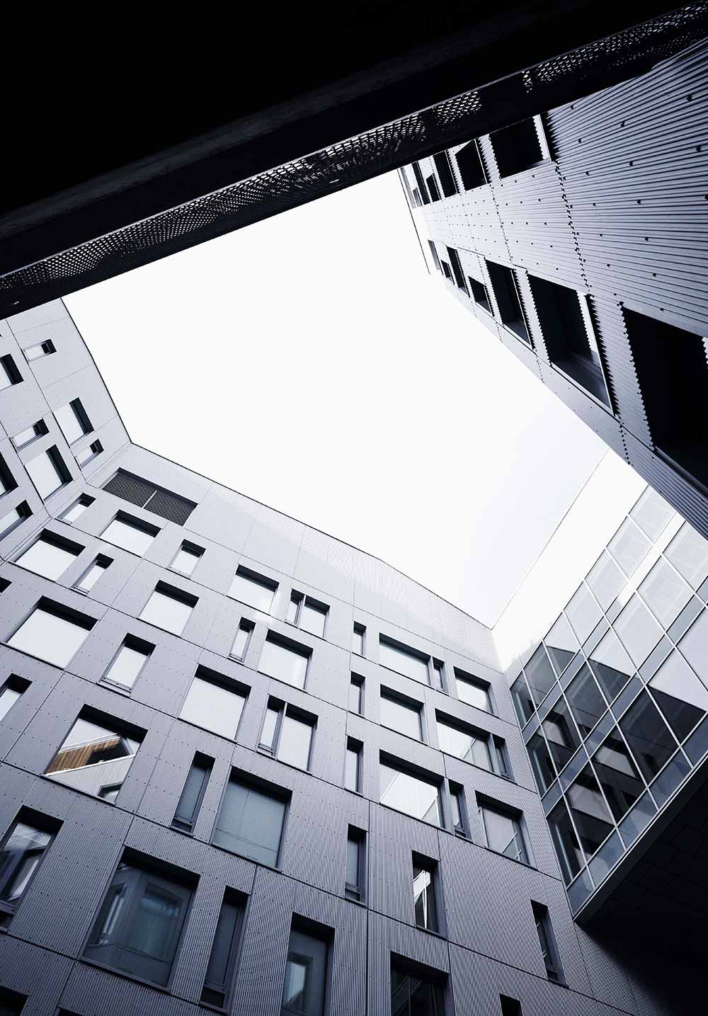 upwards perspective of modern office building exterior courtyard walls in Oslo