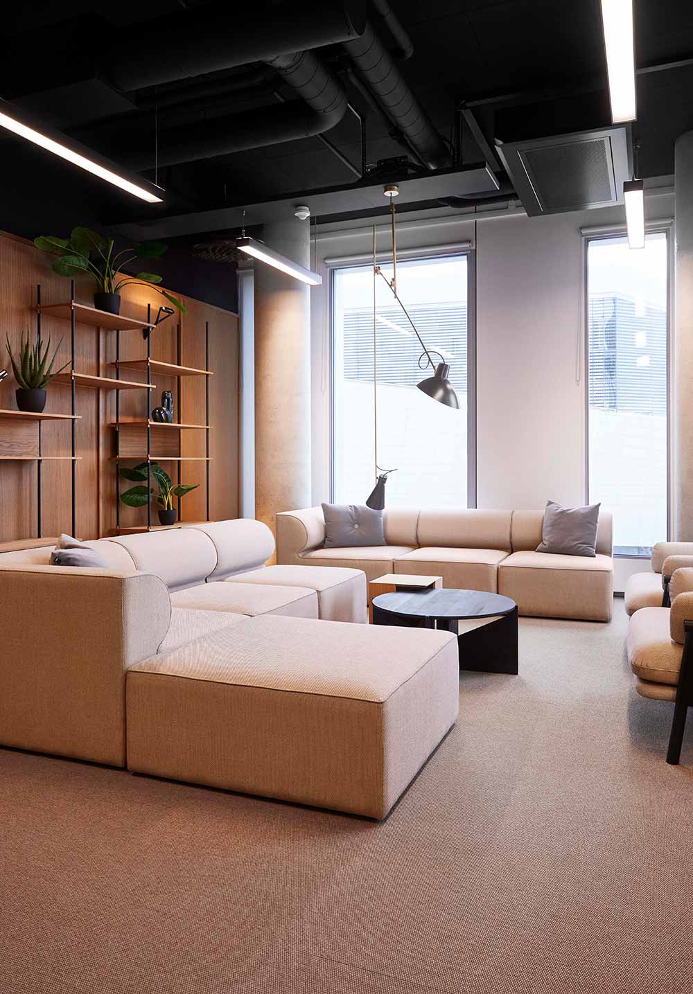 Cream coloured sofa system in a casual office meeting room at Vipps office, Oslo