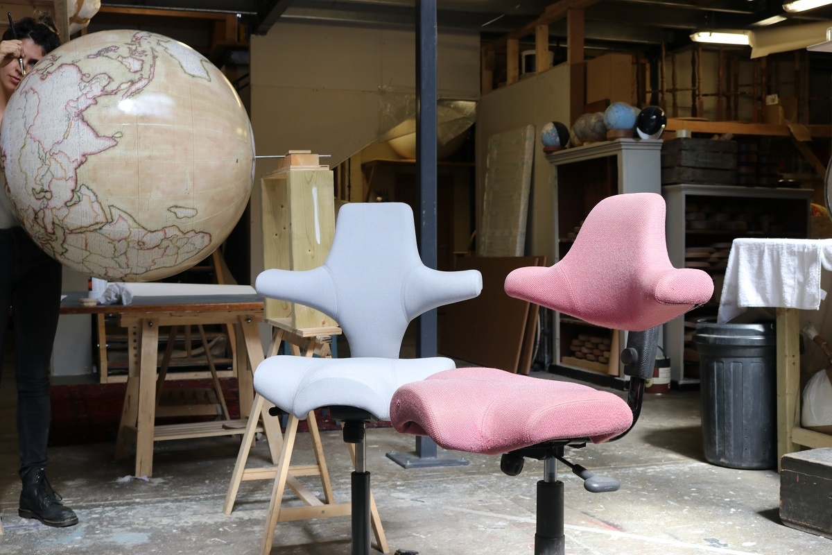 Two HÅG Capisco chairs from various years side by side in the Bellerby & Co workshop