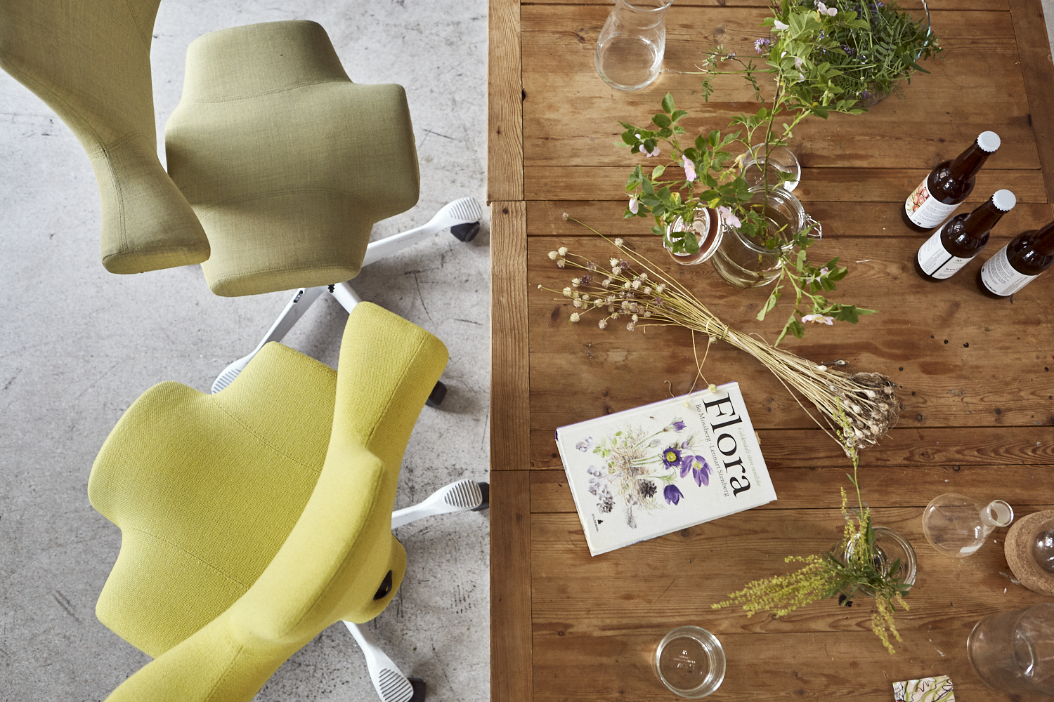 yellow and green hag capisco chairs birdseye view next to wooden desk